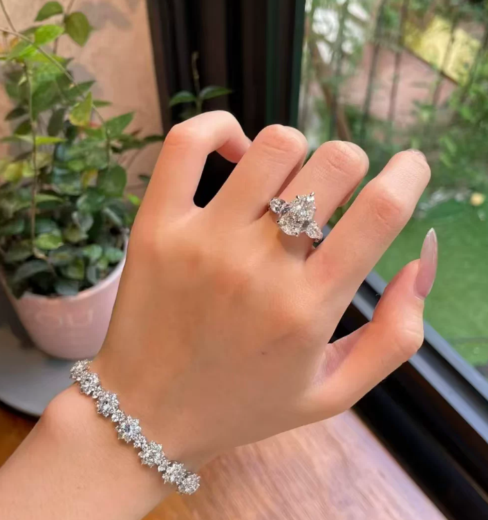 #124 VNK Luxury 4 Carat Pear Moissanite Three-Stone Ring | Timeless Side Accent Design